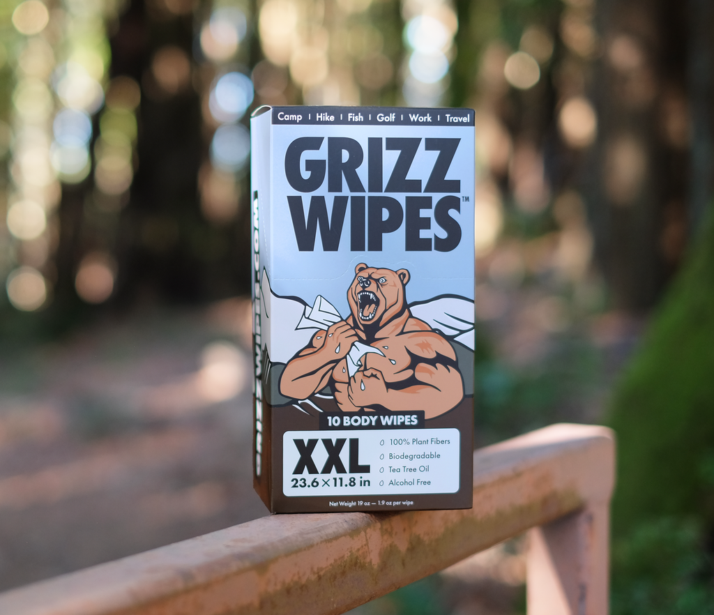 A picture of a box of Grizz Wipes set against a wooded background.