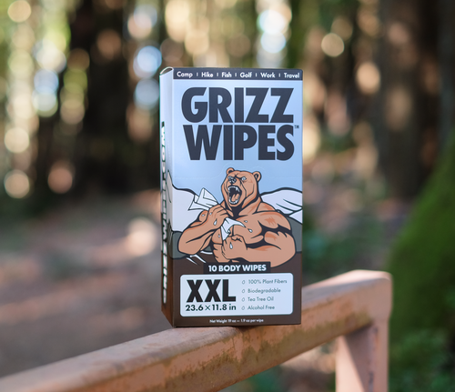 A picture of a box of Grizz Wipes set against a wooded background.